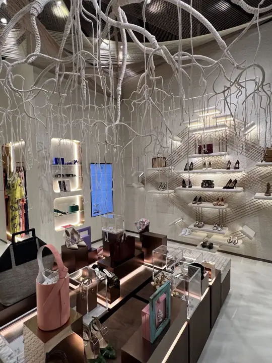 A pink structured handbag displayed inside Naseej